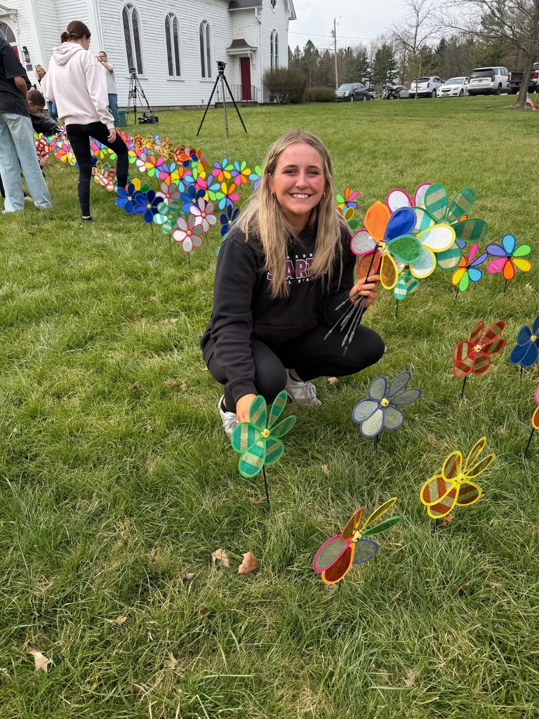 student holding a pinwheel at boardman park