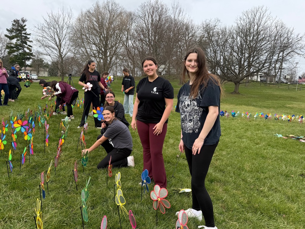 students planting pinwheels at boardman park