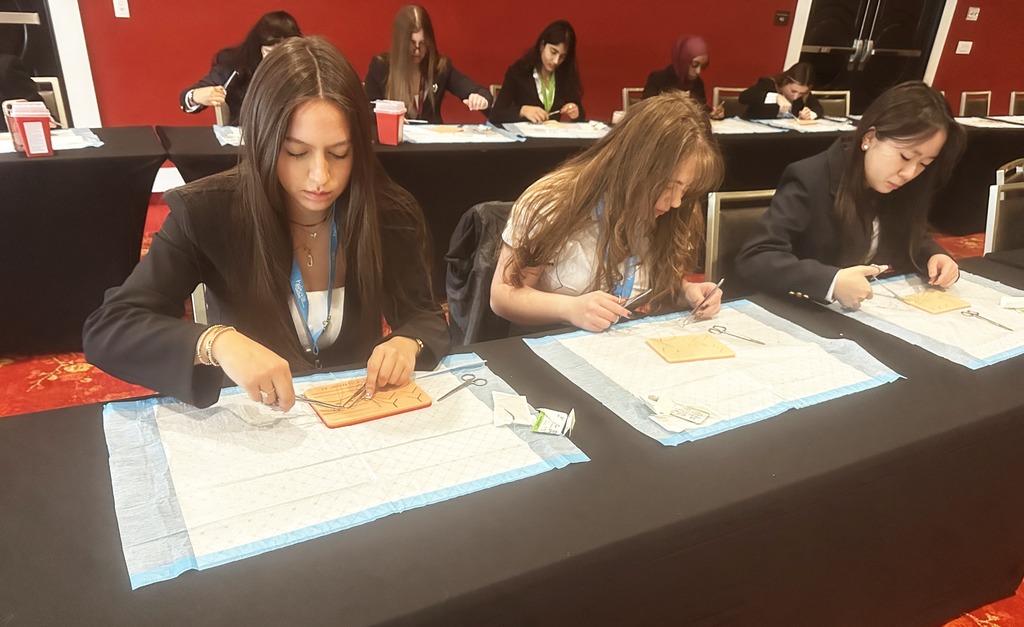 Chimacum students participate in suturing labs at the HOSA Conference in Spokane.