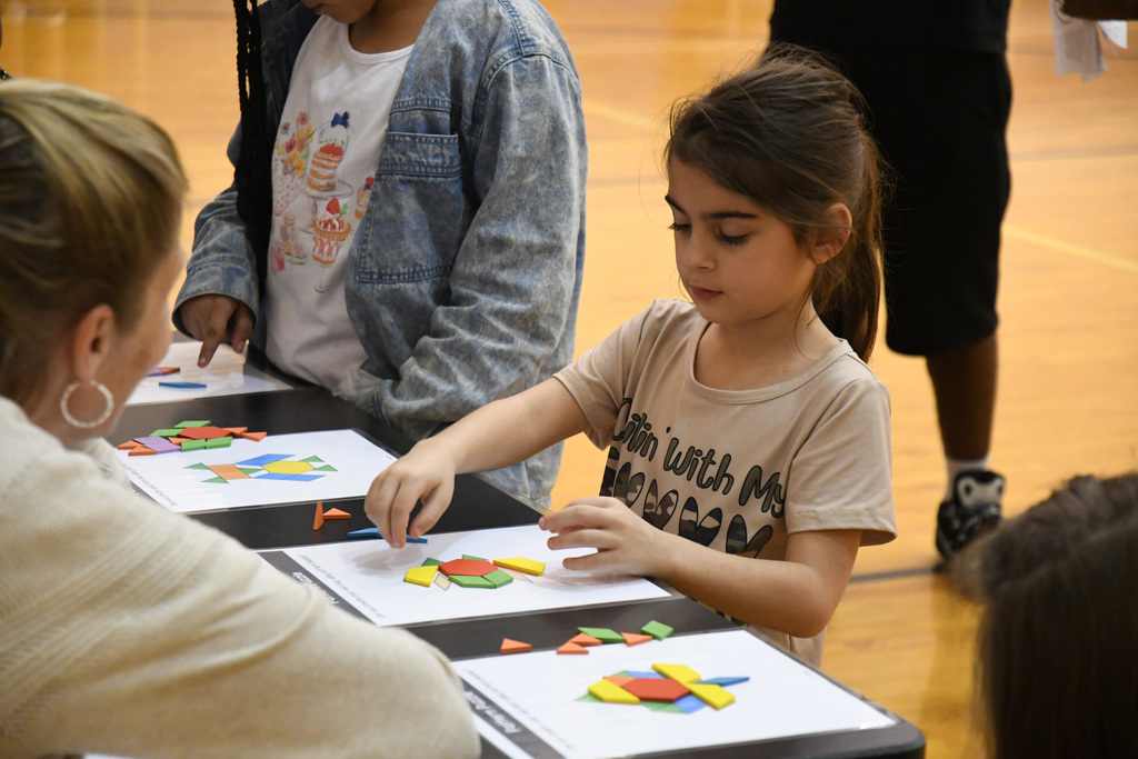 girl arranging colorful pieces