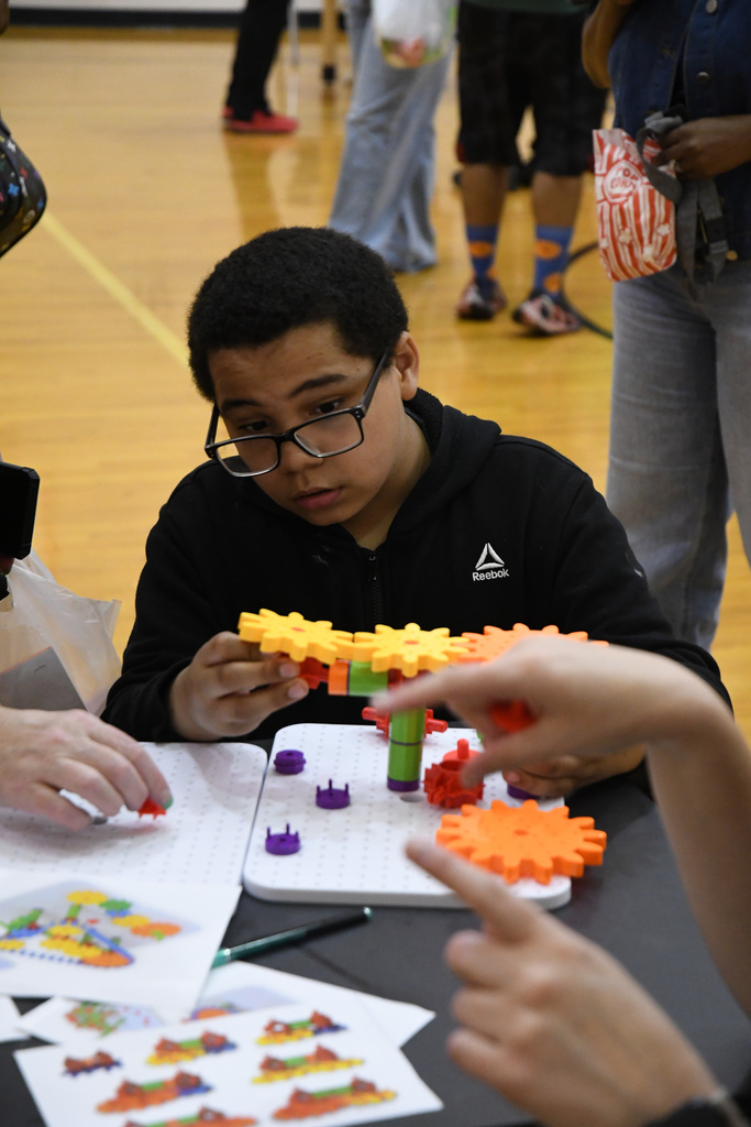 boy working on a gear puzzle