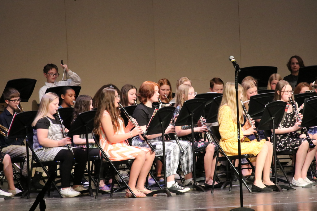 The TMS 6th grade band follows their director.
