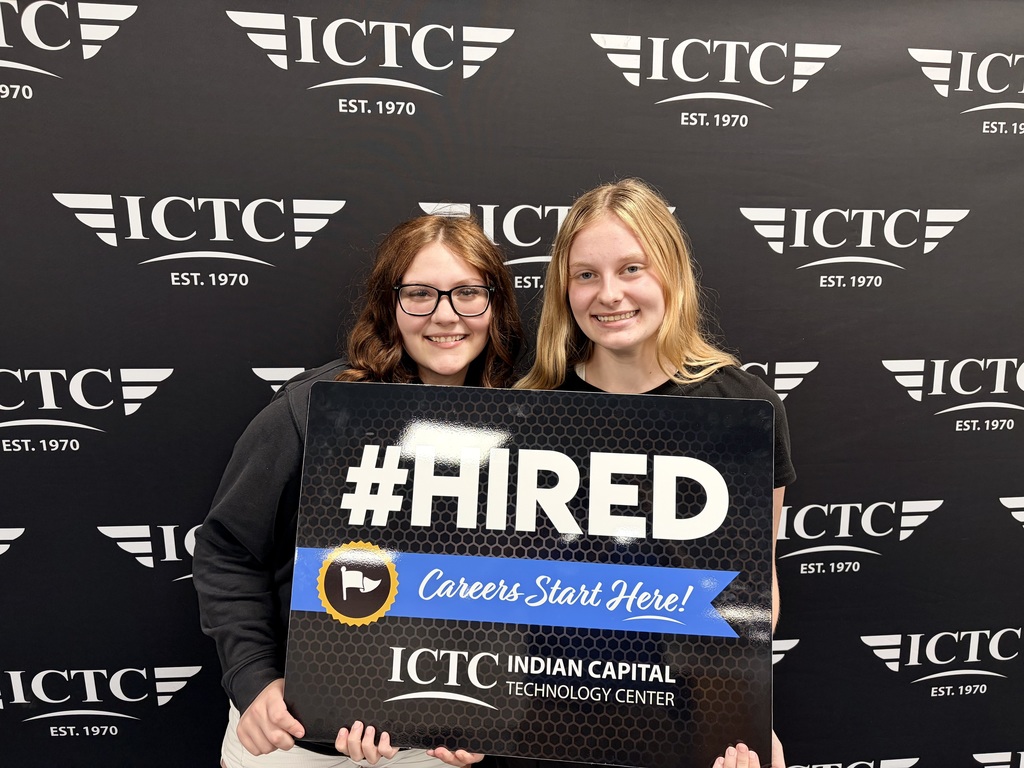 Two women smile and stand next to a sign that reads "#FIRED Careers Start Here!" against a backdrop of ICTC logos.