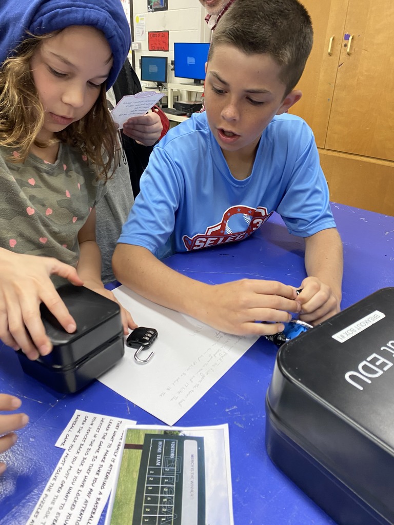 Students try to unlock the breakout box.
