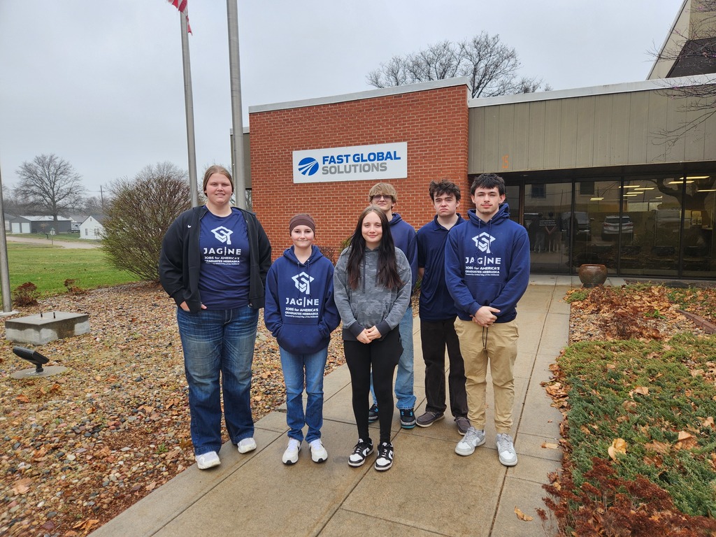 6 JAG students standing in front of FAST Globals Solutions ready to tour the manufacturing facility.