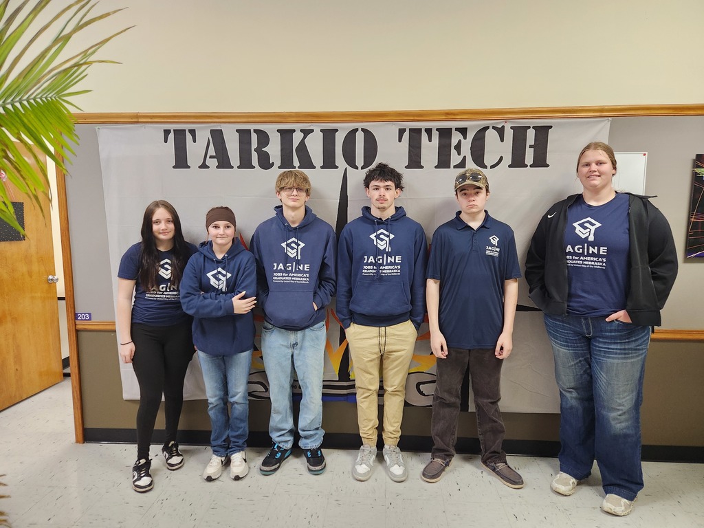 6 JAG Students standing in front of the Tarkio Tech sign after their tour.