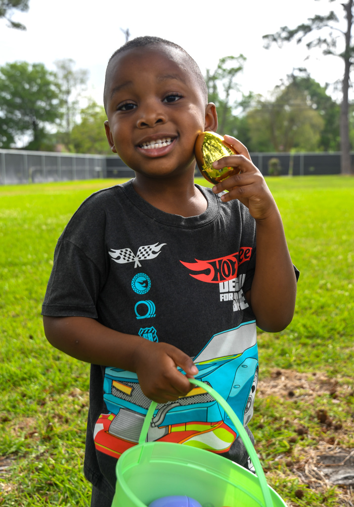 boy holding up golden easter egg