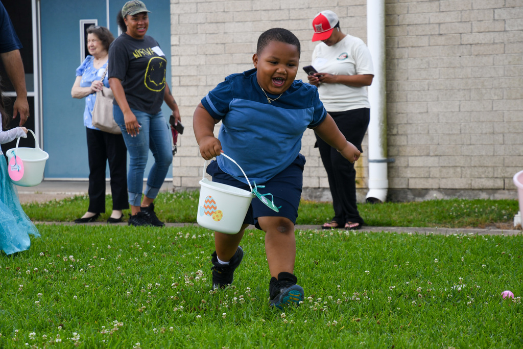 boy excitedly hunting for easter eggs