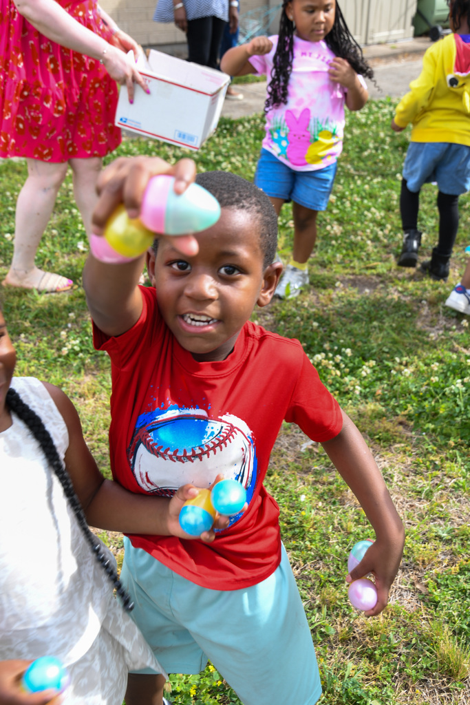 boy holding up several easter eggs