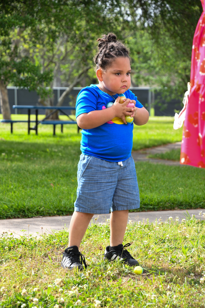 boy clutching easter eggs to chest