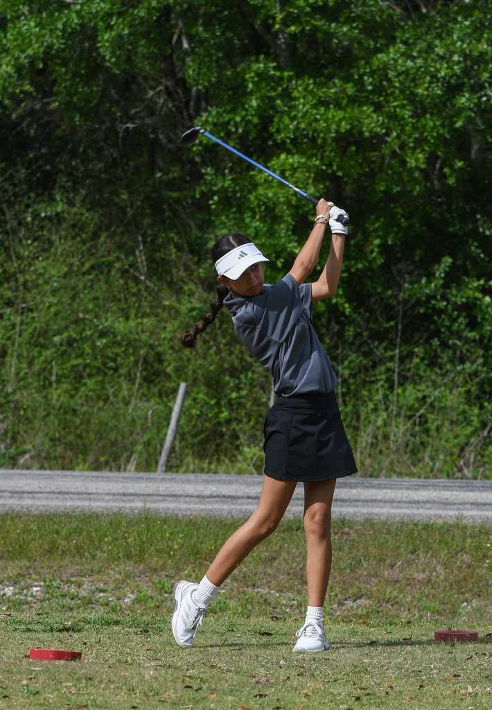 Abril Ramirez taking a swing at golf