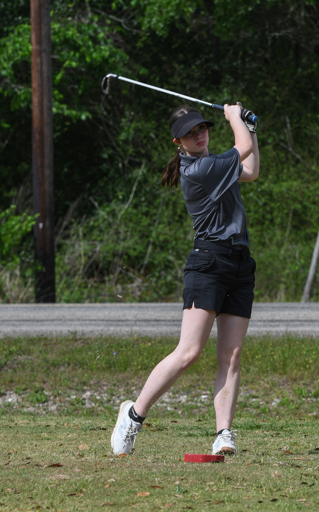 Melody Grimm taking a swing at golf