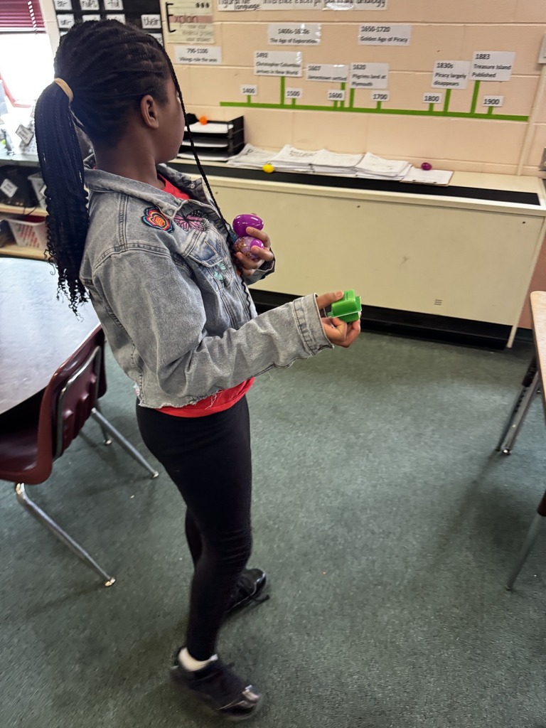A student looking where to hide the eggs she is holding in her hands. 