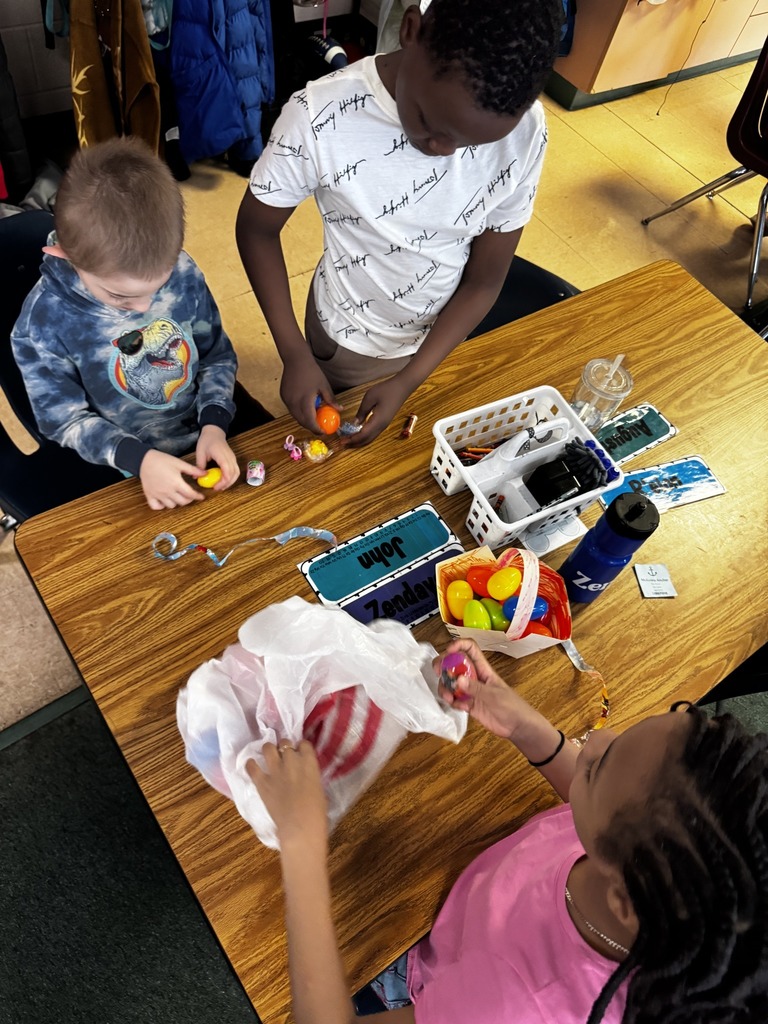 Students playing with colorful plastic eggs on the table. 