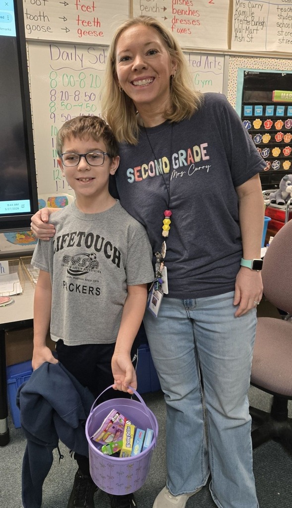 A teacher and student who is holding a purple easter basket are posing. 
