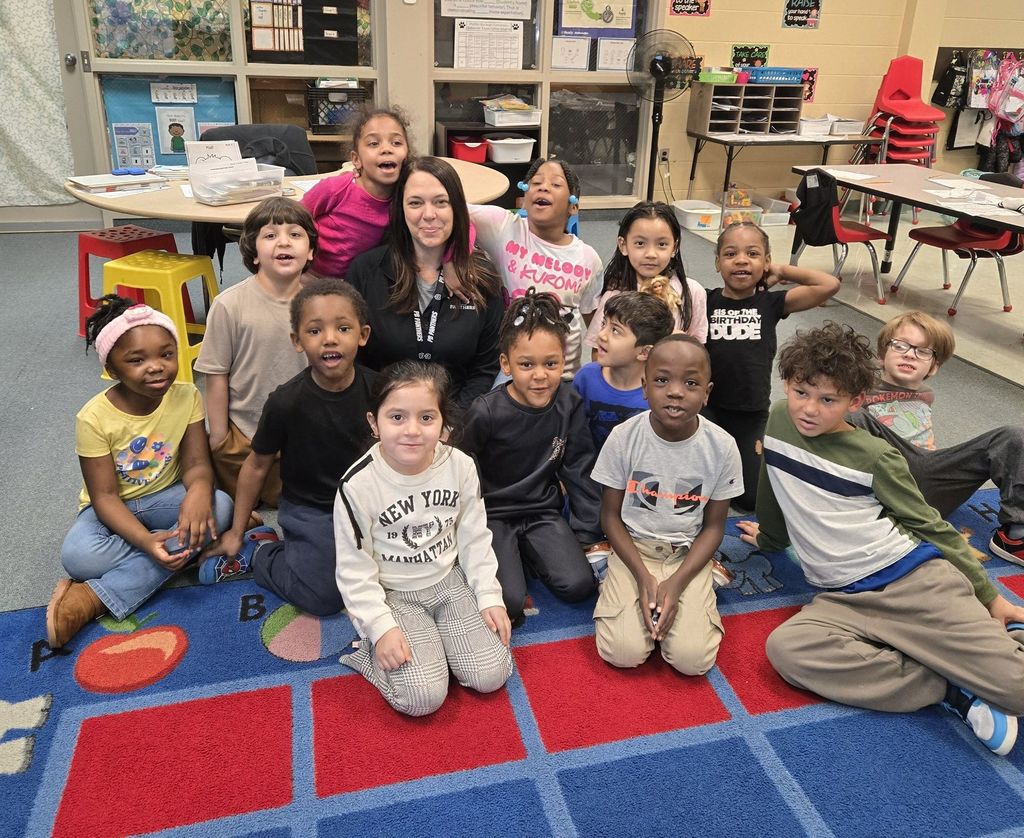 Students and a teacher posing. 