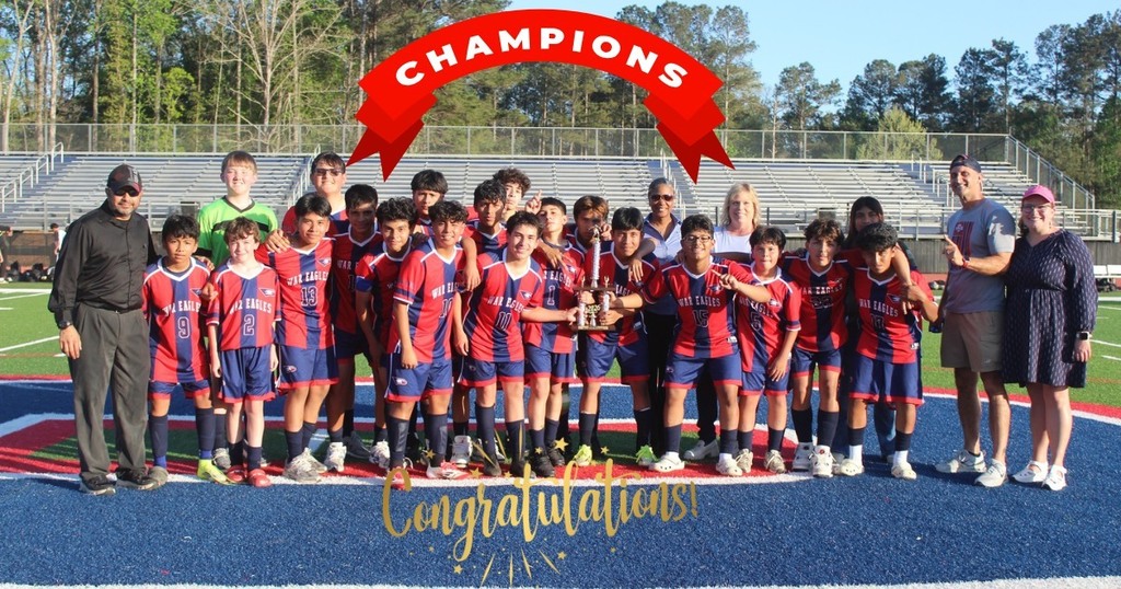A soccer team with red and blue uniforms on a field, holding a trophy, with "Champions" and "Congratulations!" text.