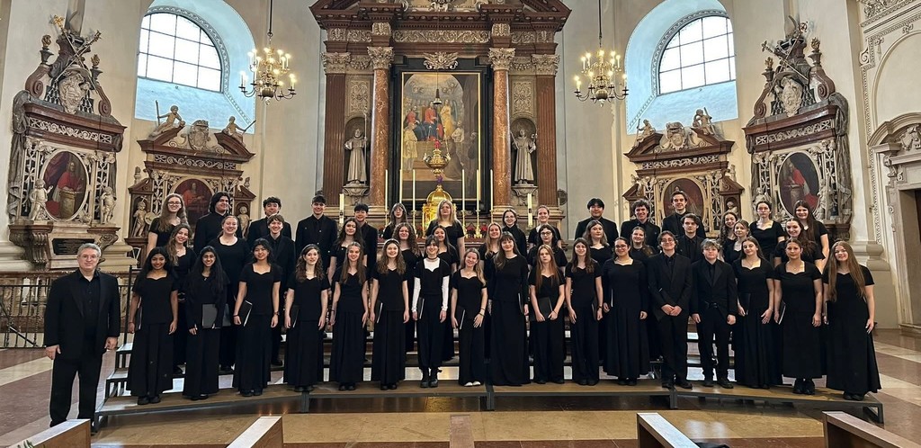 Choir students posing as a group in a church