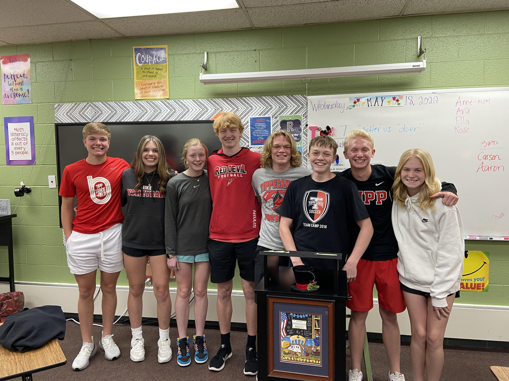 Four TMS students pose with their older brothers who were the subject of their speeches.