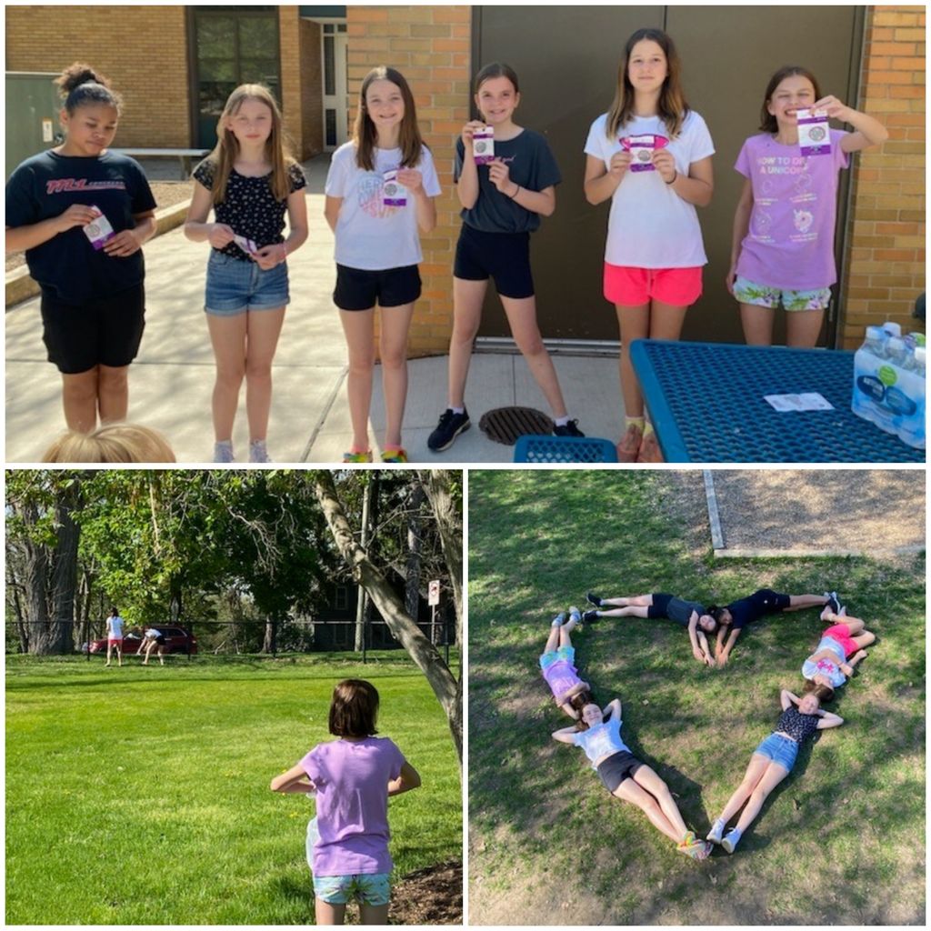 girl scouts helping clean up outside of the school