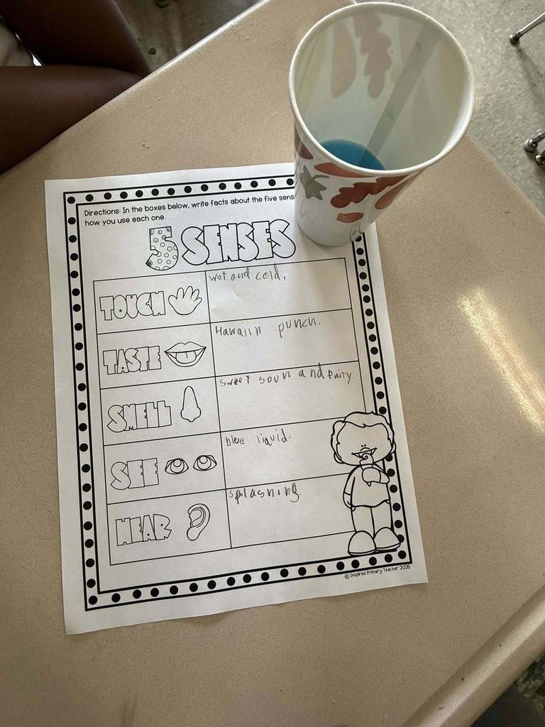 5 Senses worksheet with a cup of blue juice next to the sheet. 
