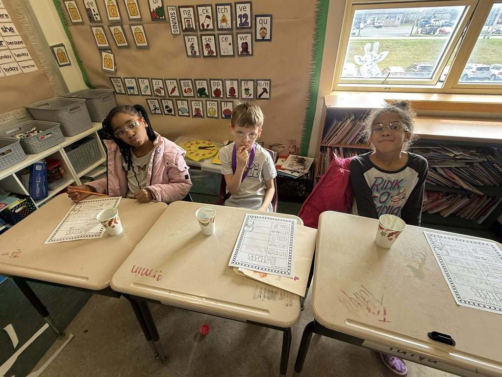 Kids posing in a classroom.