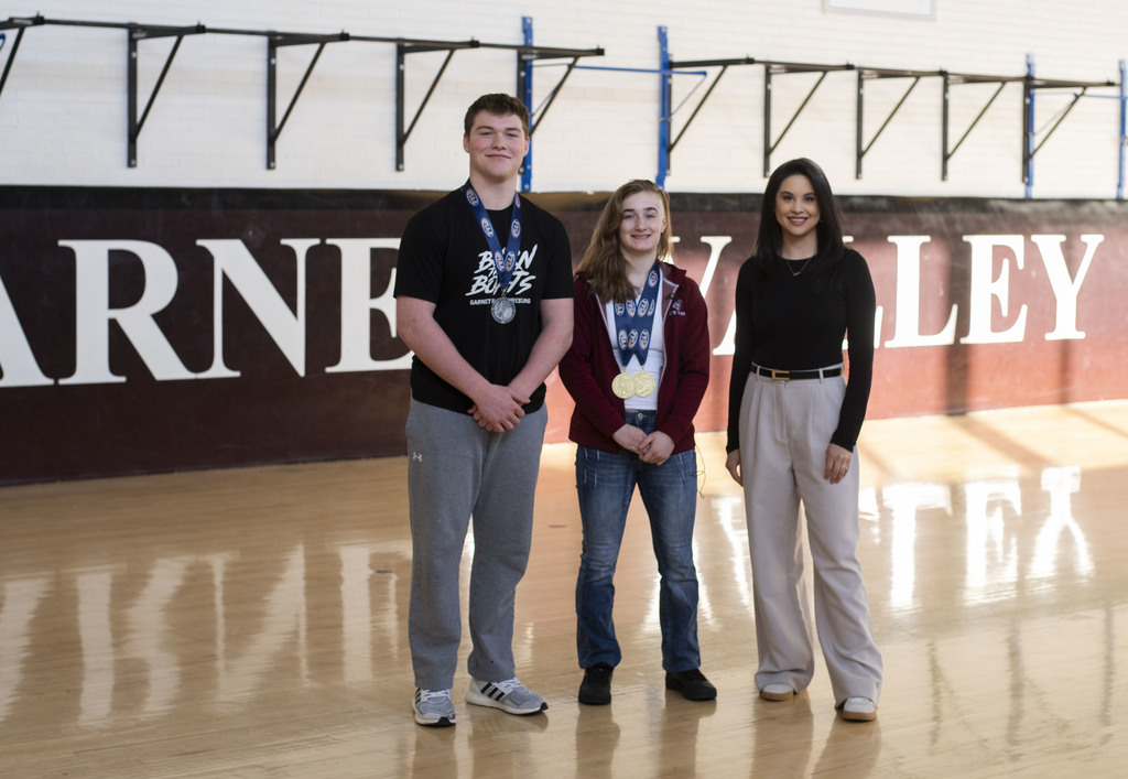 Paxton Hunt, Neve O'Byrne and CBS3 anchor, Jen Carabeo pose for the picture in the GVHS wrestling gym.