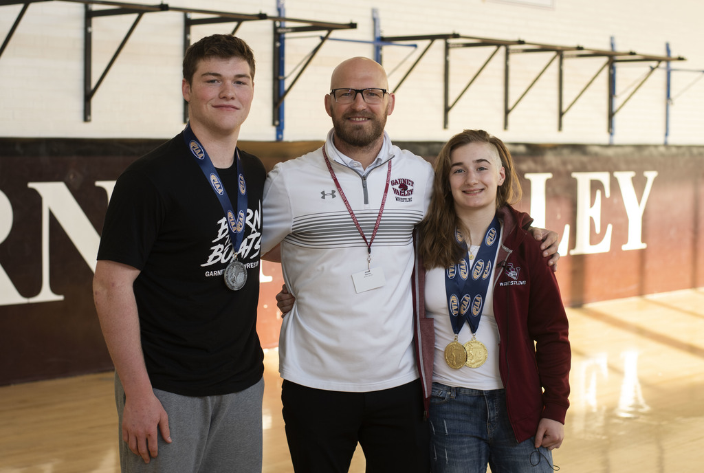 Paxton Hunt & Neve O'Byrne stand with their coach, Mr. Tate.