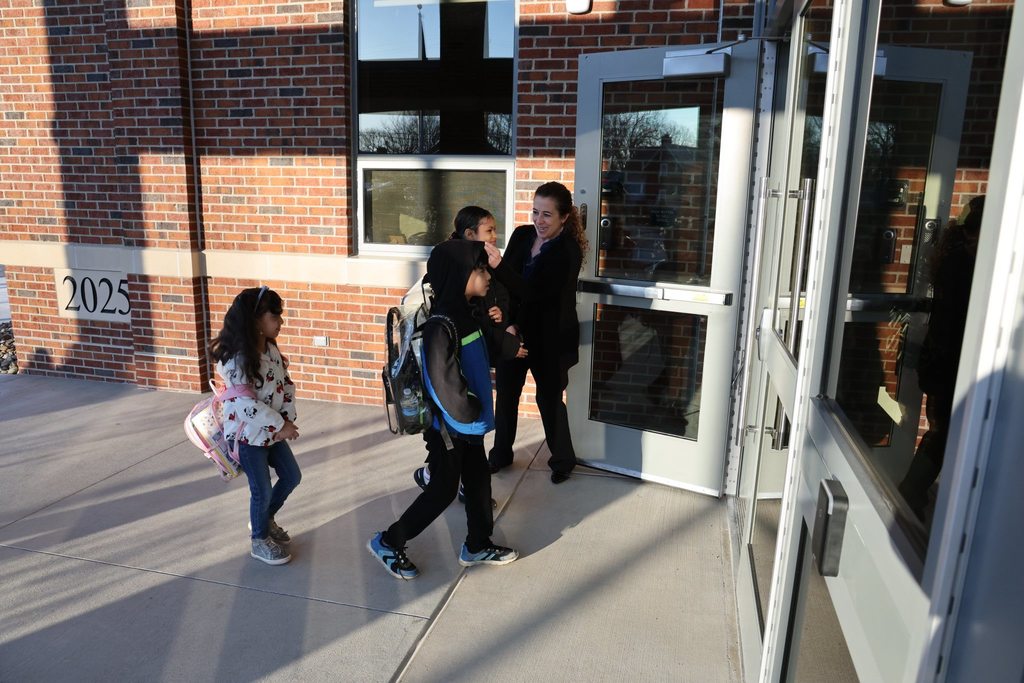 Edison Principal greeting students as they walk into the new Edison Elementary building. 