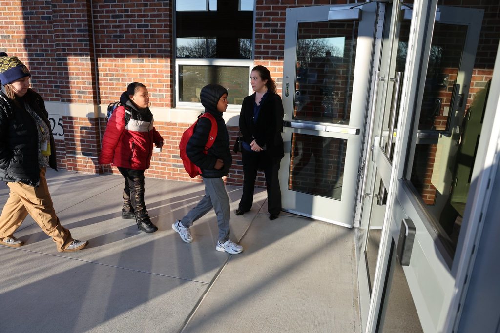 Edison Principal greeting students as they walk into the new Edison Elementary building. 