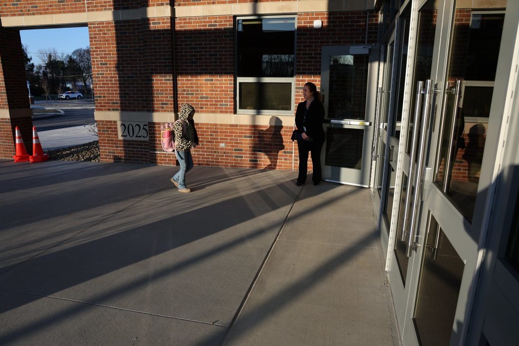 Edison Principal greeting students as they walk into the new Edison Elementary building. 