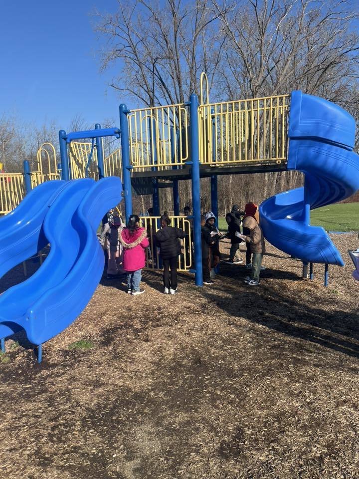 Students standing in a playground. 