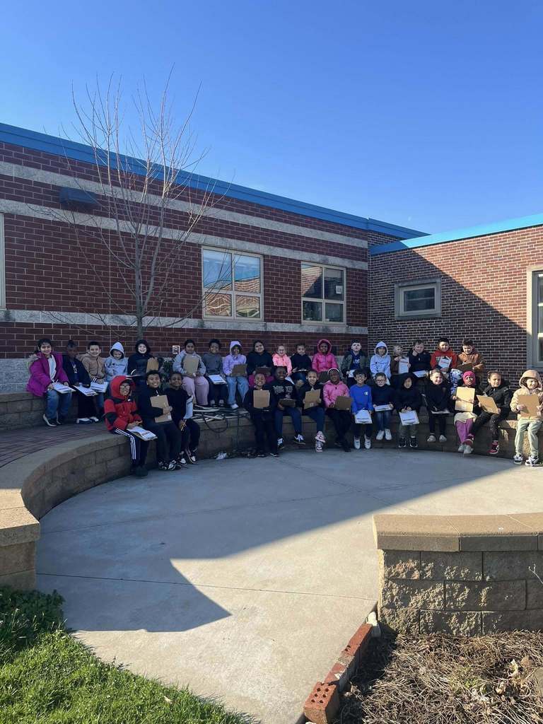 Students sitting in front of JoAnna Connell. 