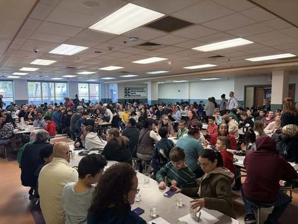 People sitting in a cafeteria. 