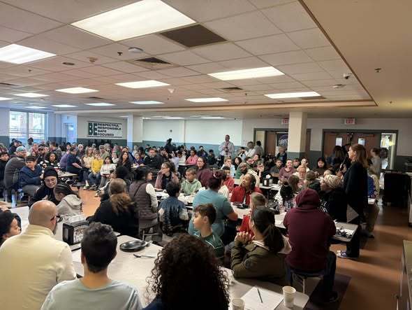 People sitting in a cafeteria. 