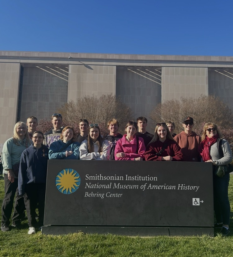 students pictured in front of Smithsonian Institution sign 