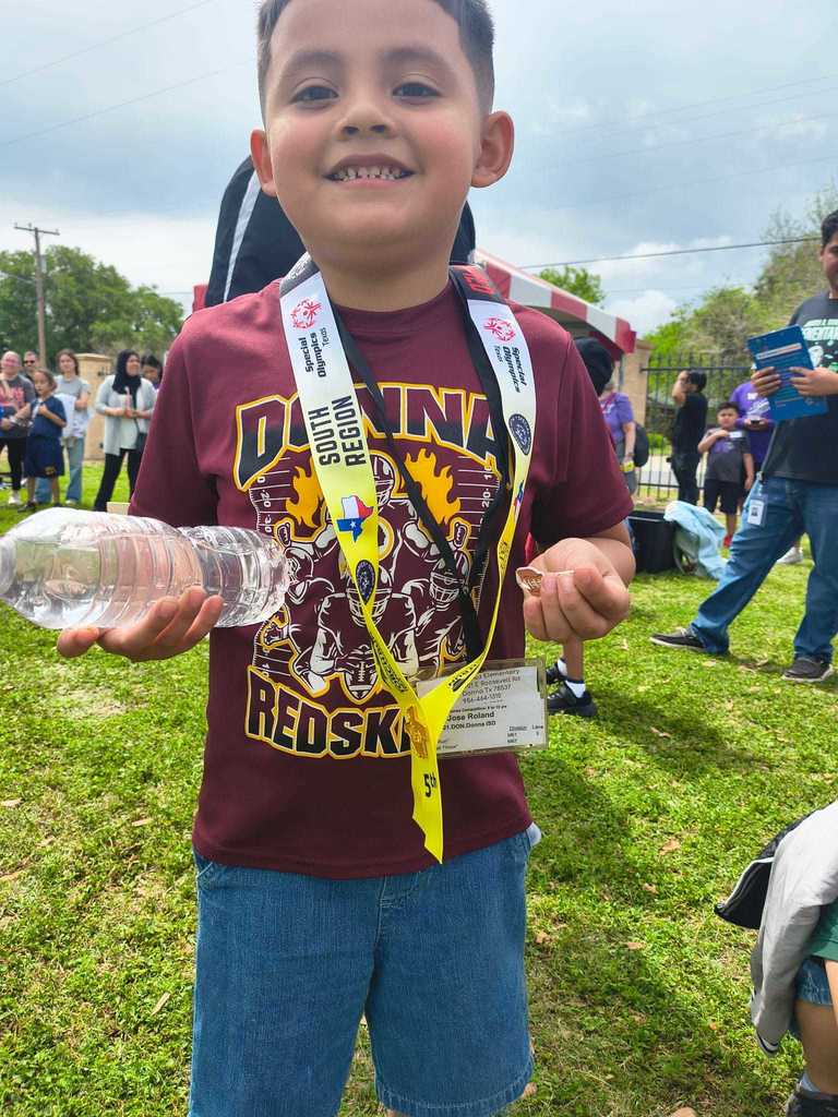 boy maroon shirt with medal 