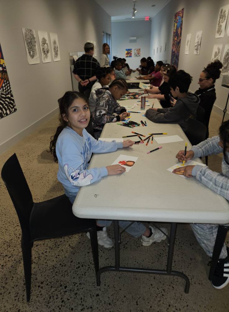Students making artwork in the Erie Art Museum. 