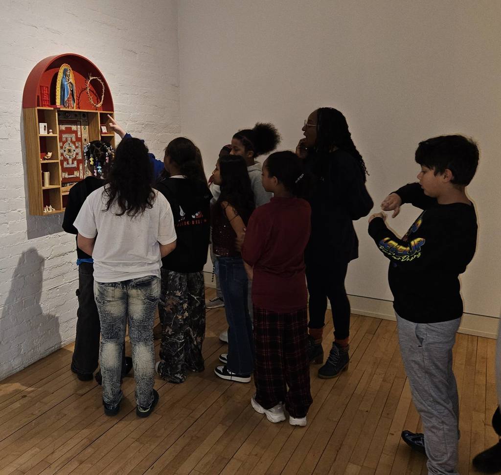 Students looking at artwork in the Erie Art Museum. 