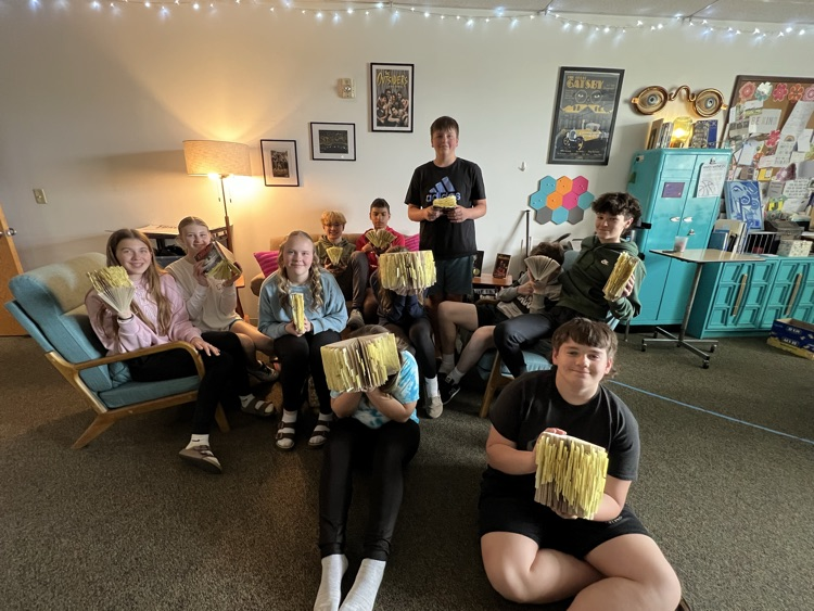students holding books with post-it notes in them. 