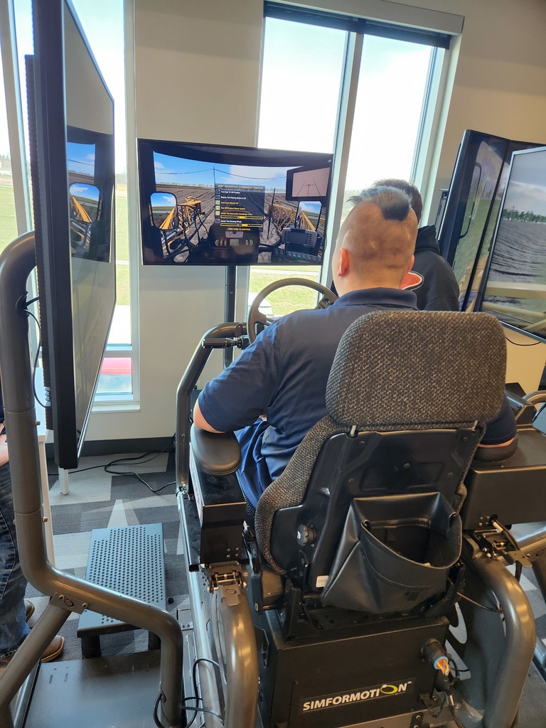 1 JAG student participating in an agricultural sprayer simulation activity