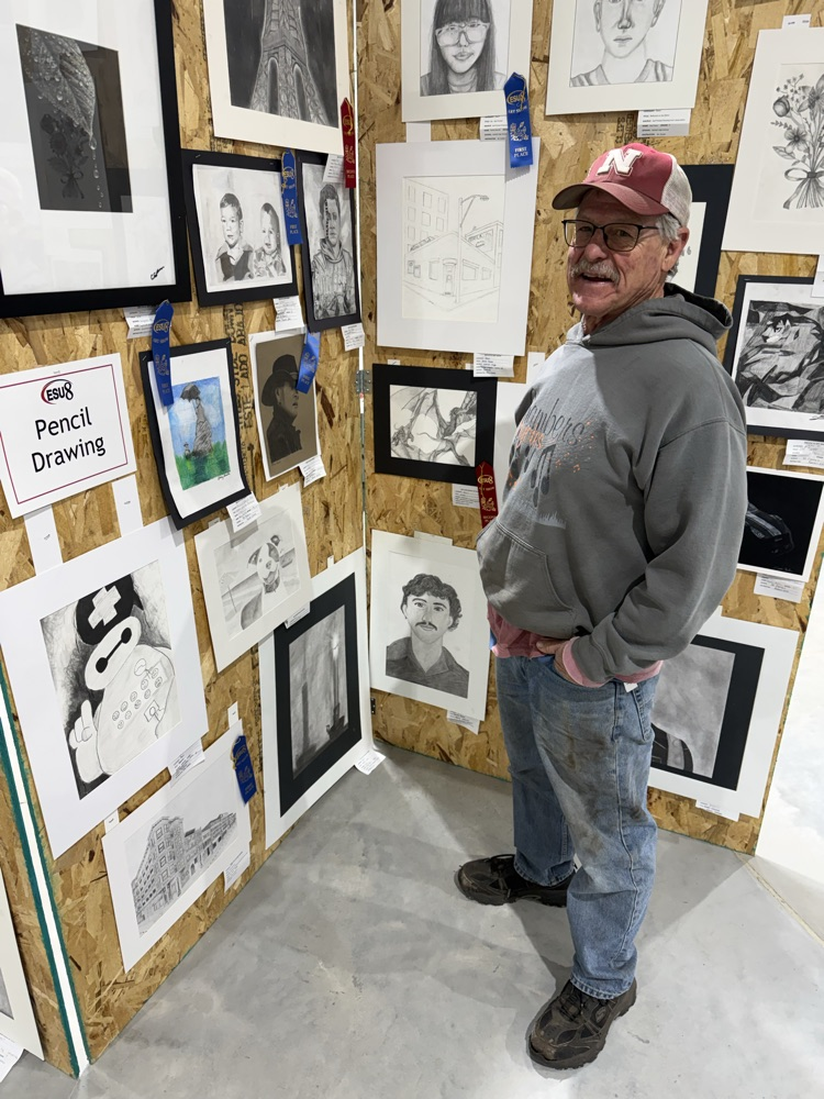 man looks at art work