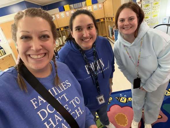 Teachers posing in the new Edison Building. 