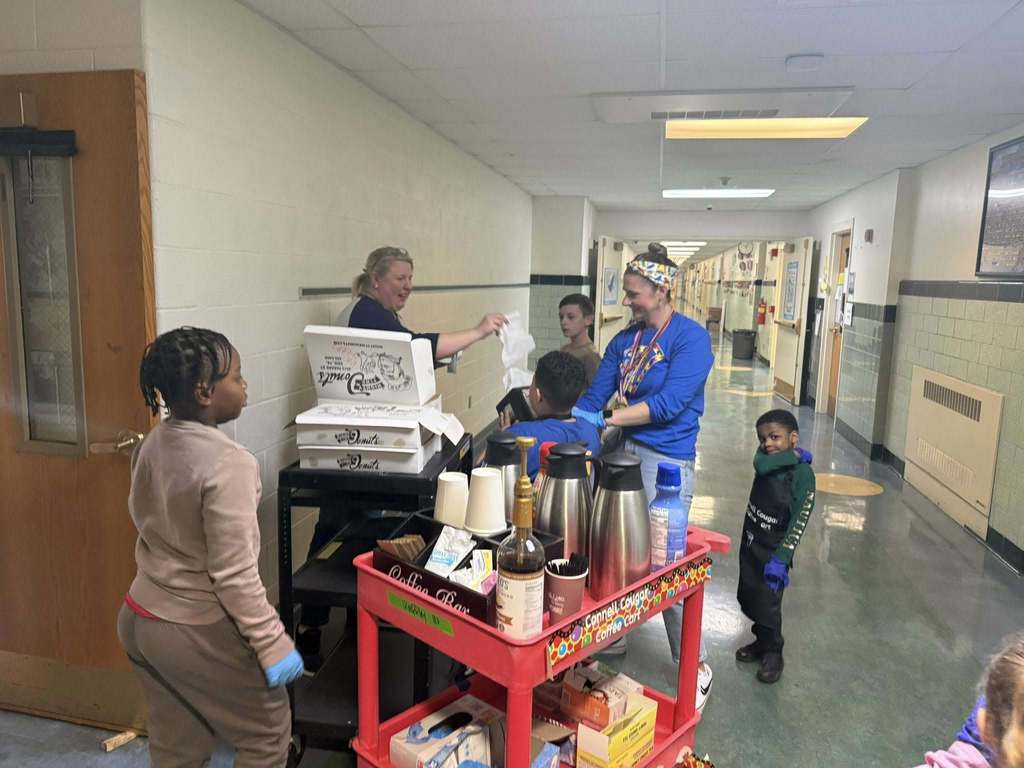 Students and staff at Edison passing out coffee and donuts.