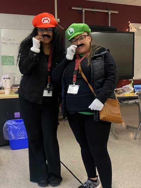 A pair of teachers dressed like mario and luigi