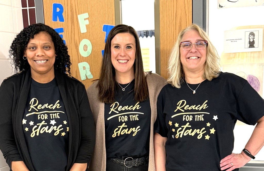 3 staff members wearing matching "Reach for the Stars" t shirts