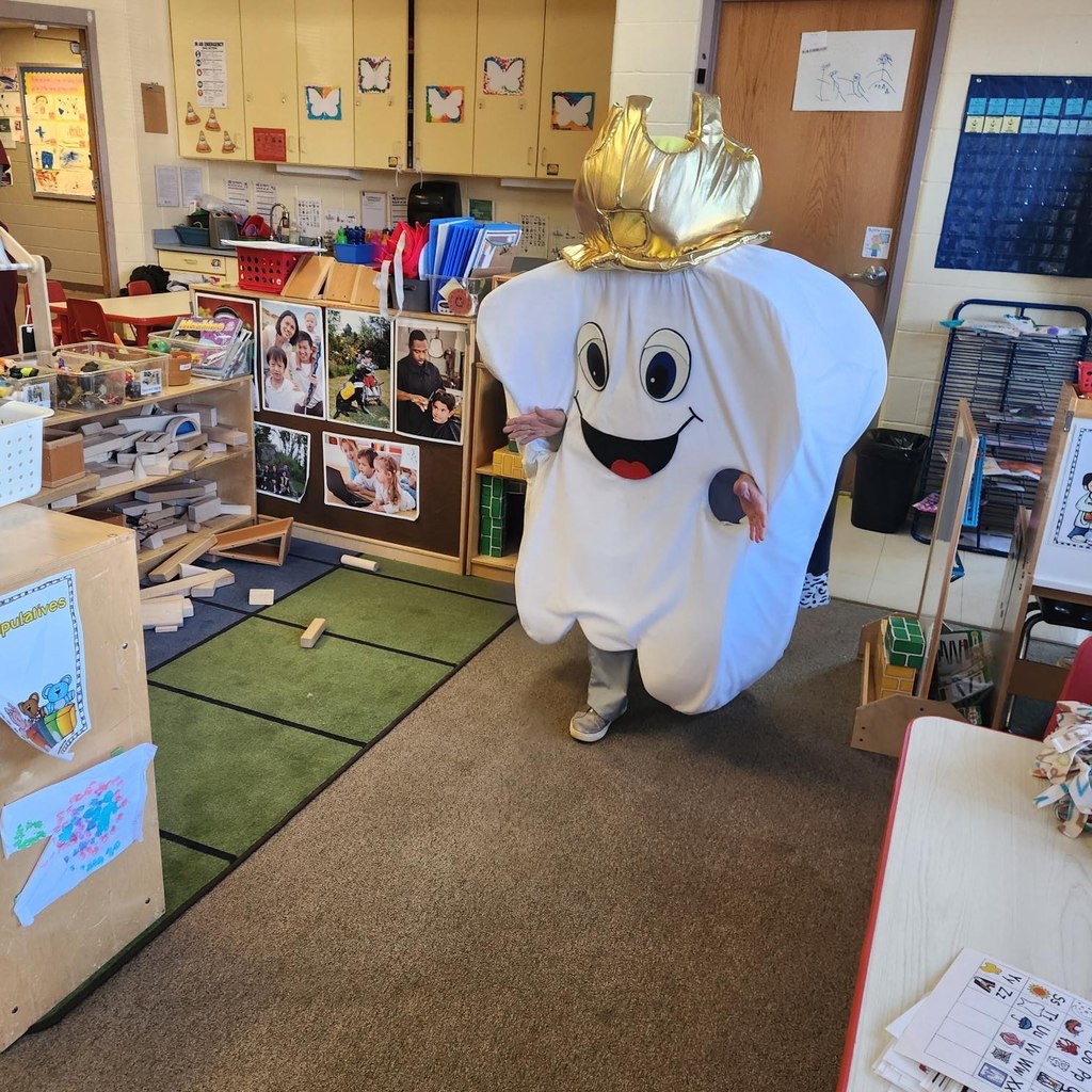 A tooth costume with a crown.