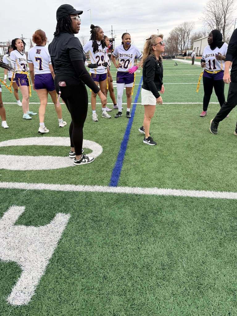 Erie High Royals Girl Flag Football Team and staff on the field. 