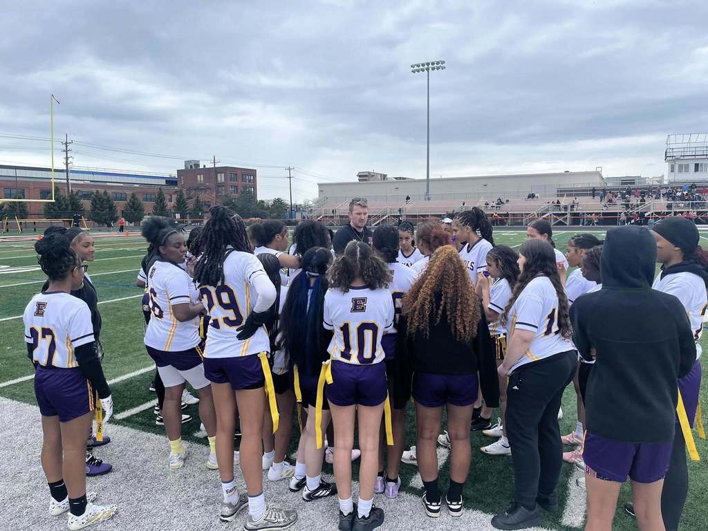 Erie High Royals Girl Flag Football Team huddle.