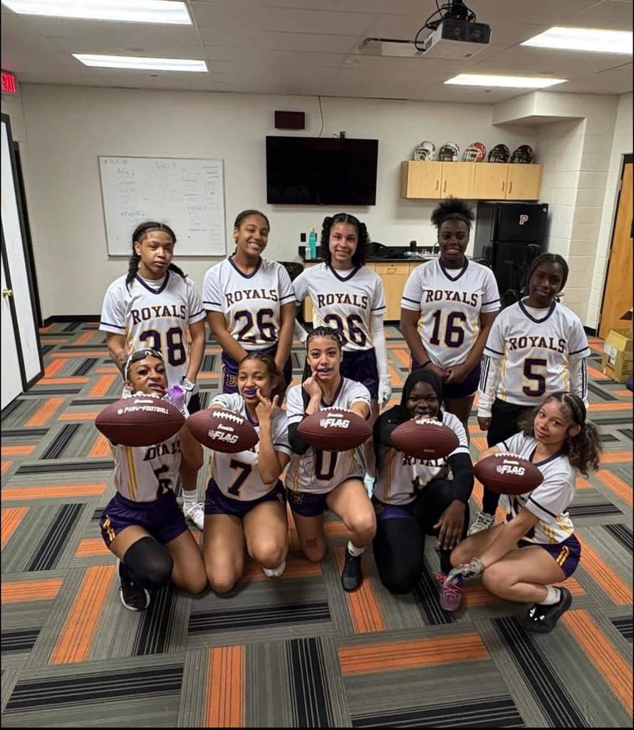 Erie High Royals Girl Flag Football Team posing with footballs in hand. 